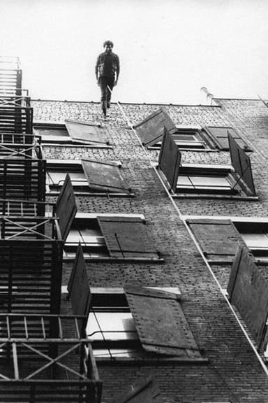 Man Walking Down the Side of a Building poster